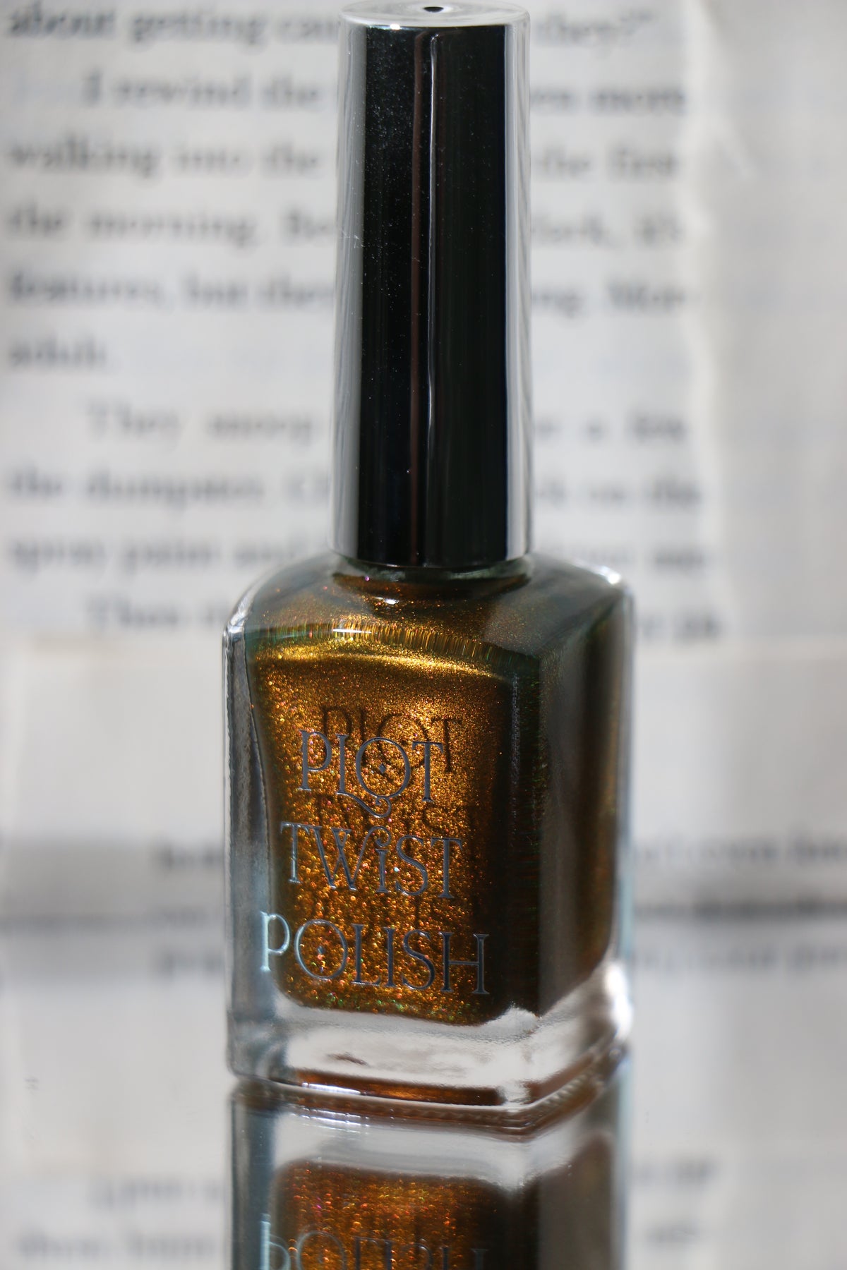 A glass bottle of a copper shimmer nail polish.